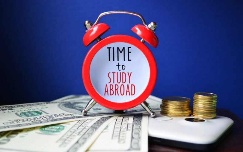 Time,To,Study,Abroad.,Sign,On,Red,Clocks,With,Cash
