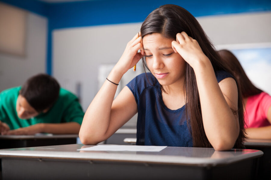 Cute,Girl,Looking,Worried,While,Taking,A,Test,In,A